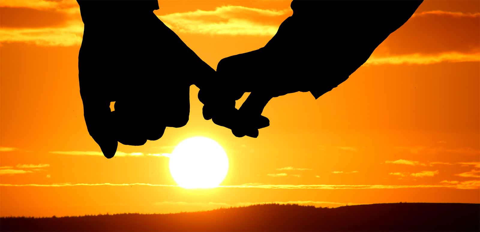 Couple Therapy with two people holding hands againsts a sun rise