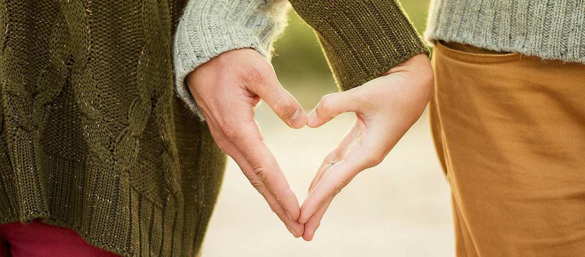 Couple Therapy - a couple holding hands to make a heart shape